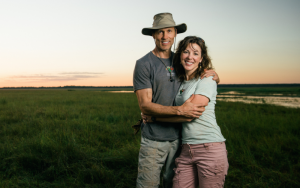 Michele Stumpe and husband standing in front of african safari