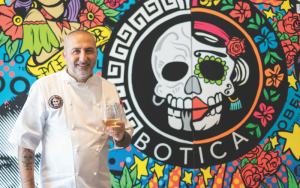 Chef mimmo standing in front of Botica mural