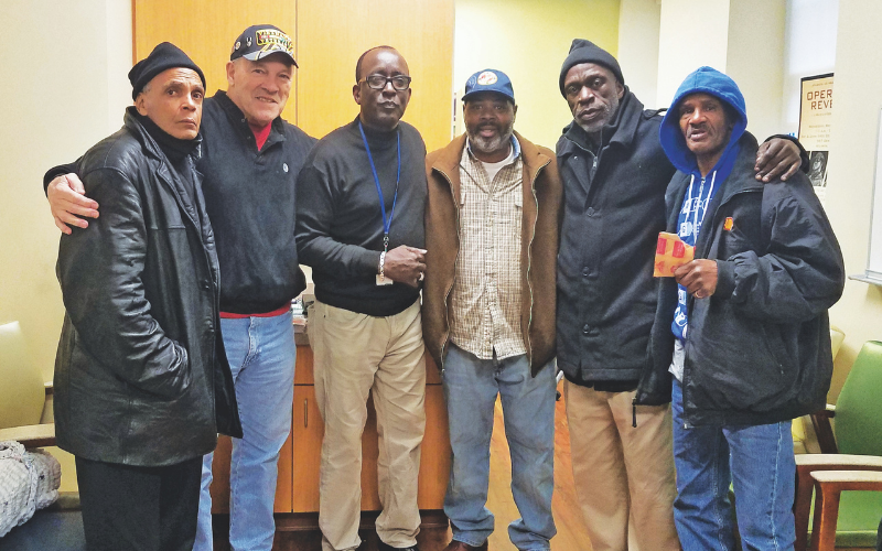 Veterans and volunteers standing together