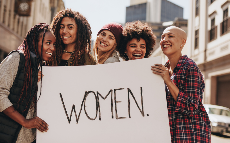 women holding up a sign