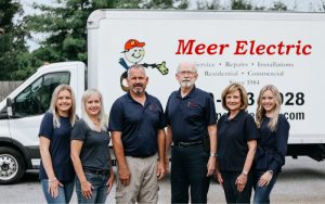 a group of people in front of a truck