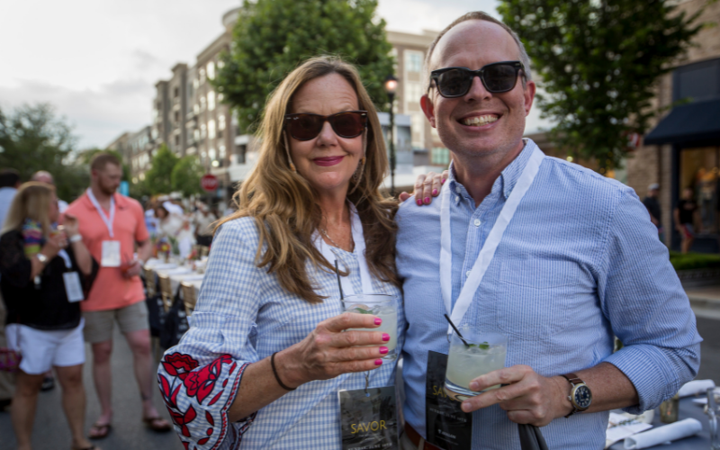 two people holding drinks