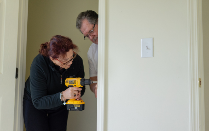 2 people drilling a hole