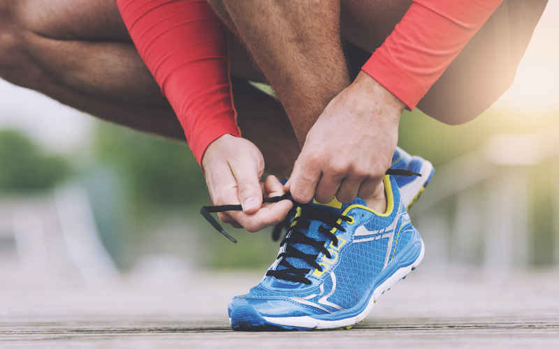 man tying shoelace