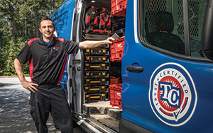 Plumber standing in front of a Mr. Plumber's van