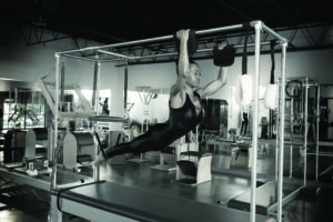 Black and white photo of woman doing pilates