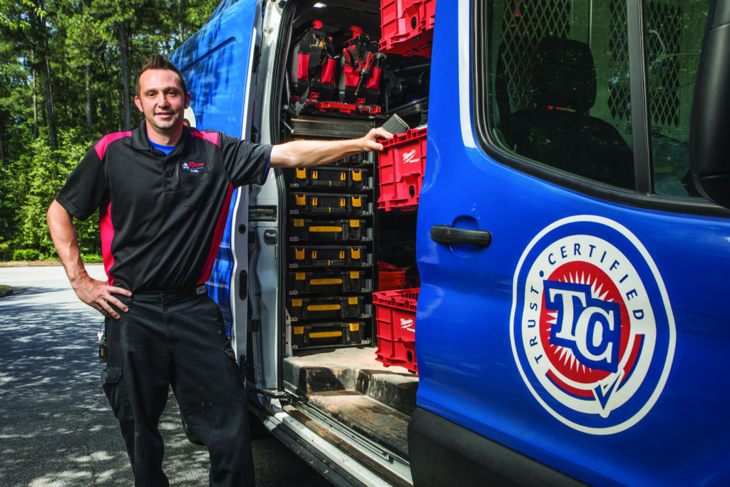 man next to blue truck