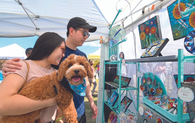 Woman holding dog at festival