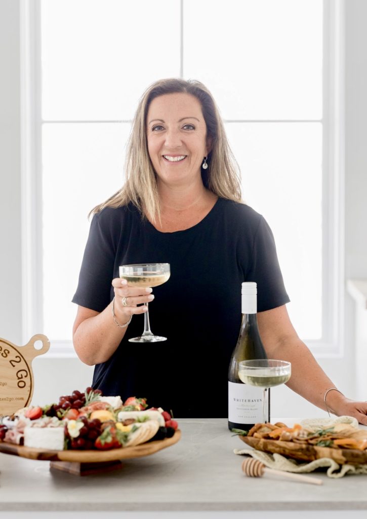 Woman in black shirt holding wine