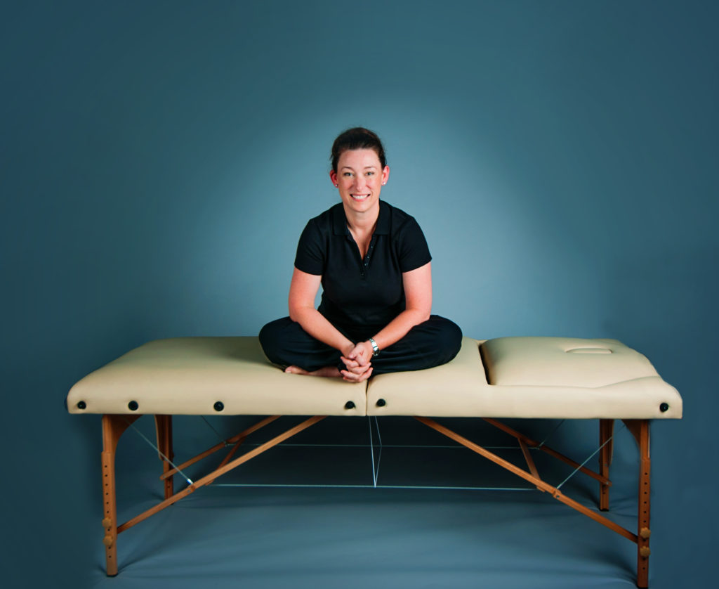 Woman in blue room on massage table