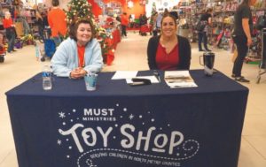 Two women at toy shop table