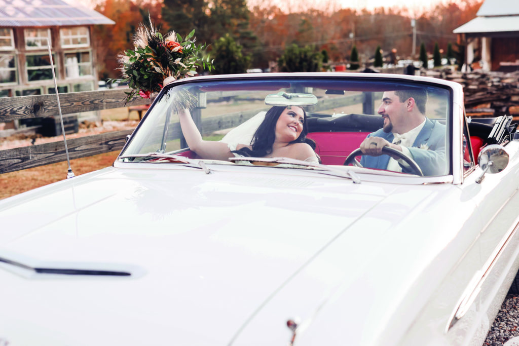 Married couple in white getaway car