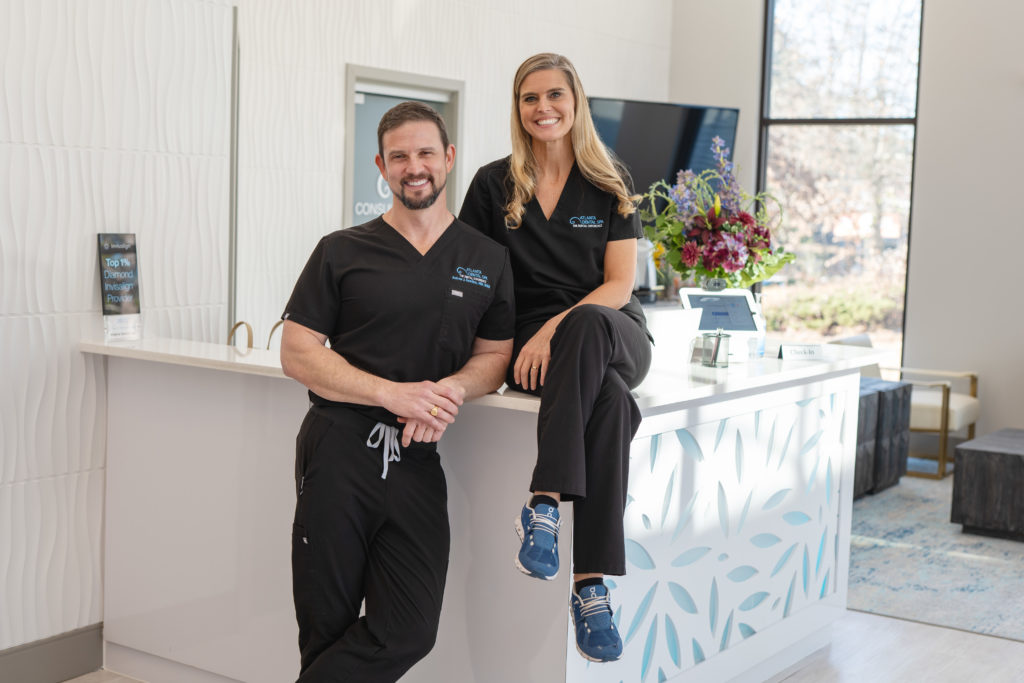 Man and woman in black scrubs in office