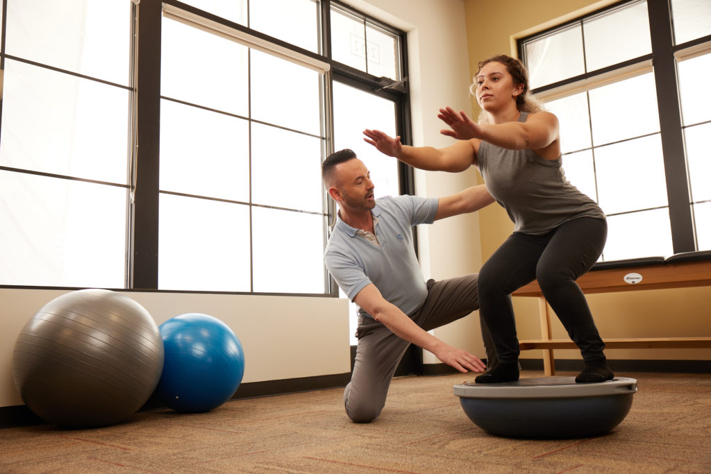 Women squatting doing pilates