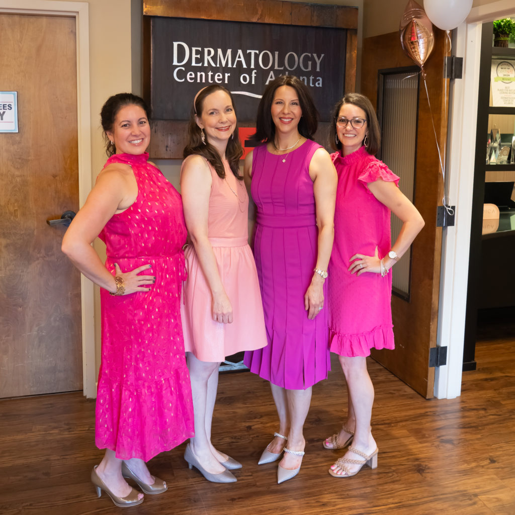 4 women in pink dresses