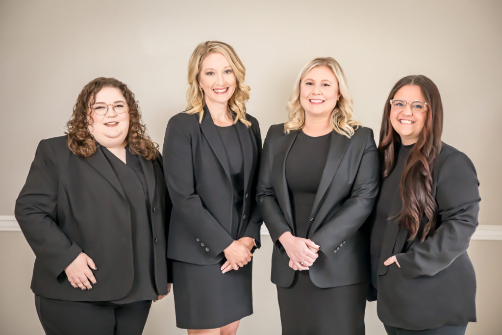 4 women in black suits